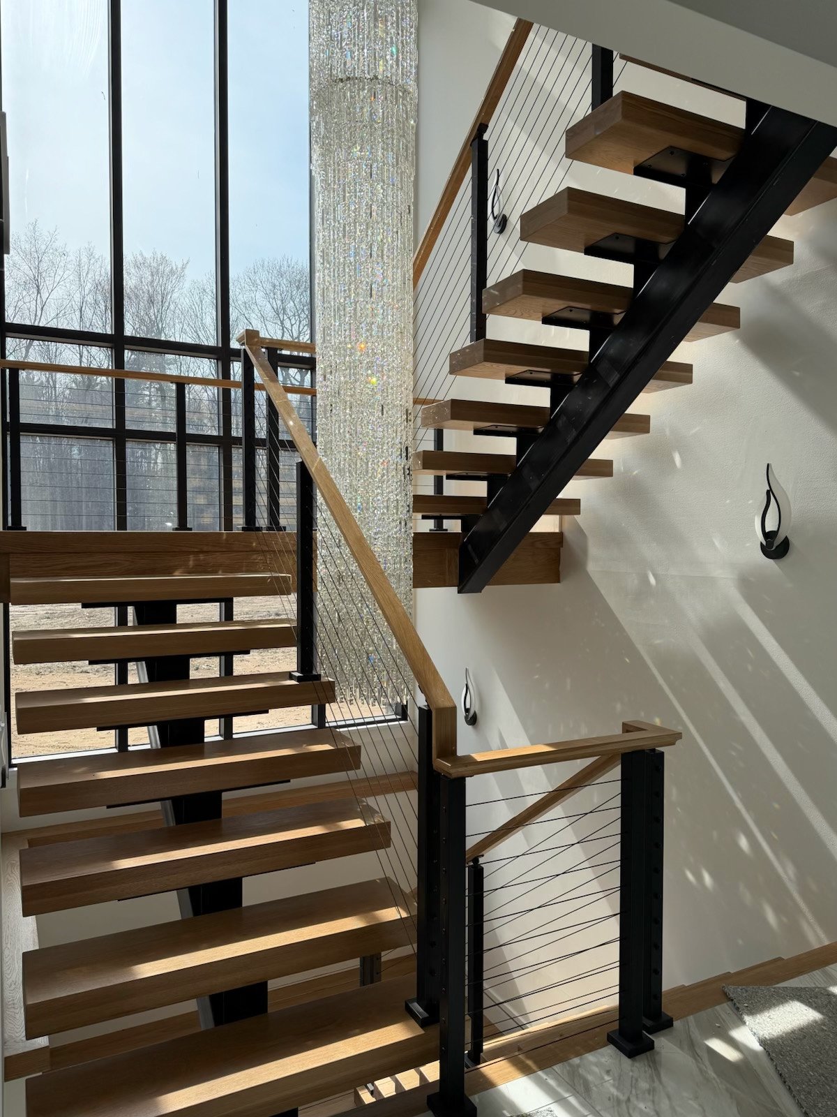 Modern open-riser staircase with wood treads and dark steel stringers